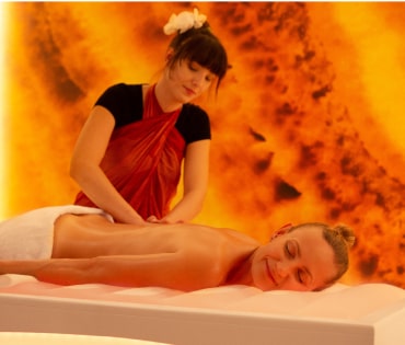 A woman relaxing while receiving a soothing massage in a tranquil spa setting.