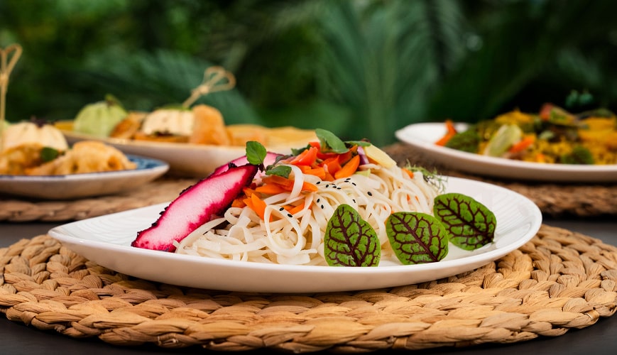 A vibrant table displaying an assortment of Asian cuisine.